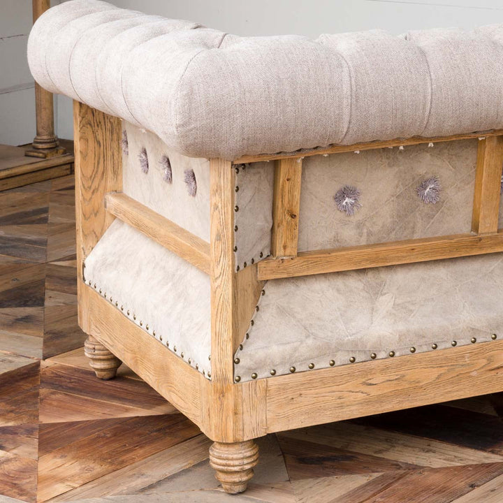 Aged Oak and beige canvas tufted accent chair detail - The Coastal Compass Home Decor