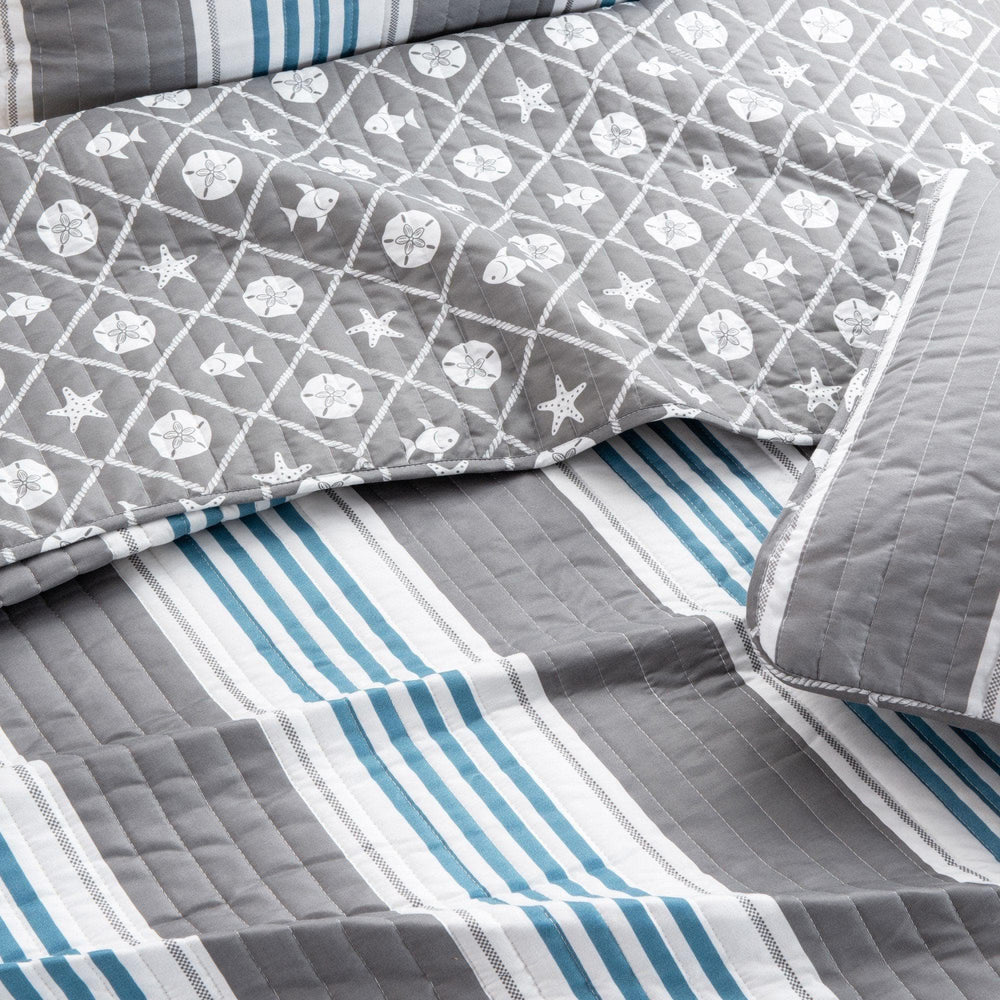 Gray and blue striped quilt with starfish and sand dollar pattern