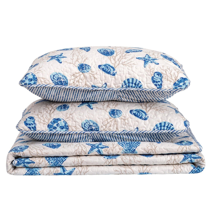 Stack of blue and white patterned pillows on a white background