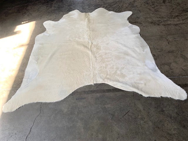 Ivory, off-white Brazilian cowhide rug - The Coastal Compass Home Decor