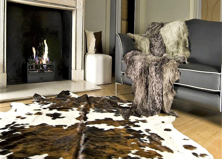 Brazilian tri color cowhide rug in living room - The Coastal Compass Home Decor