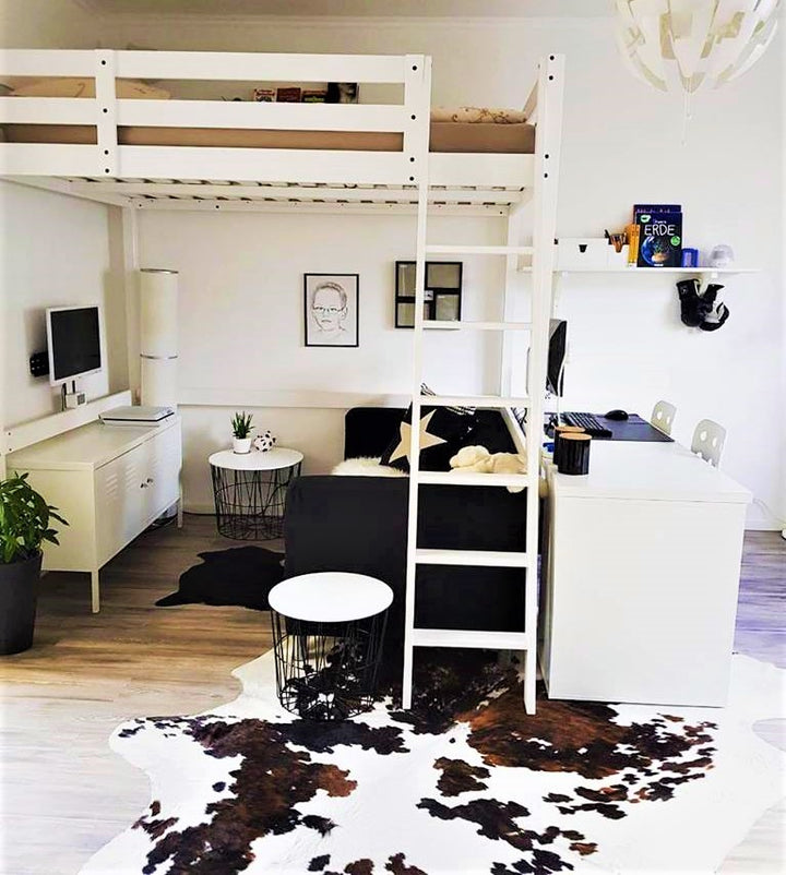 Brazilian tri color cowhide rug in bedroom - The Coastal Compass Home Decor