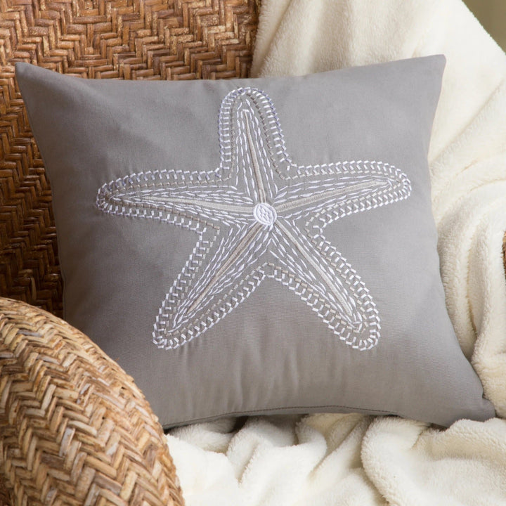 White and taupe embroidered starfish on grey accent pillow. Coastal Compass Home Decor