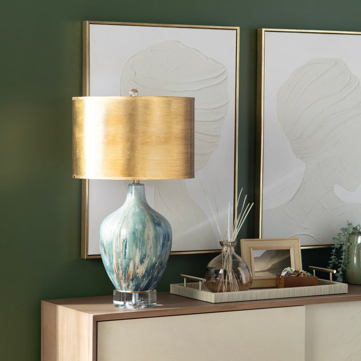Aurelia Ocean Glass Lamp on wood console against green wall with framed artwork and decor