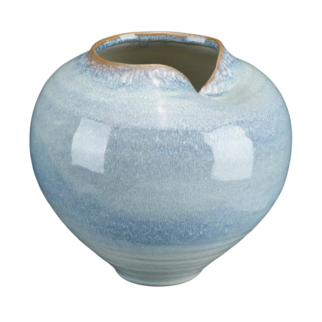 A round ceramic pitcher with a wide opening, featuring a glossy glaze that transitions from light blue at the top to a darker blue-gray at the base, with a rustic brown rim.