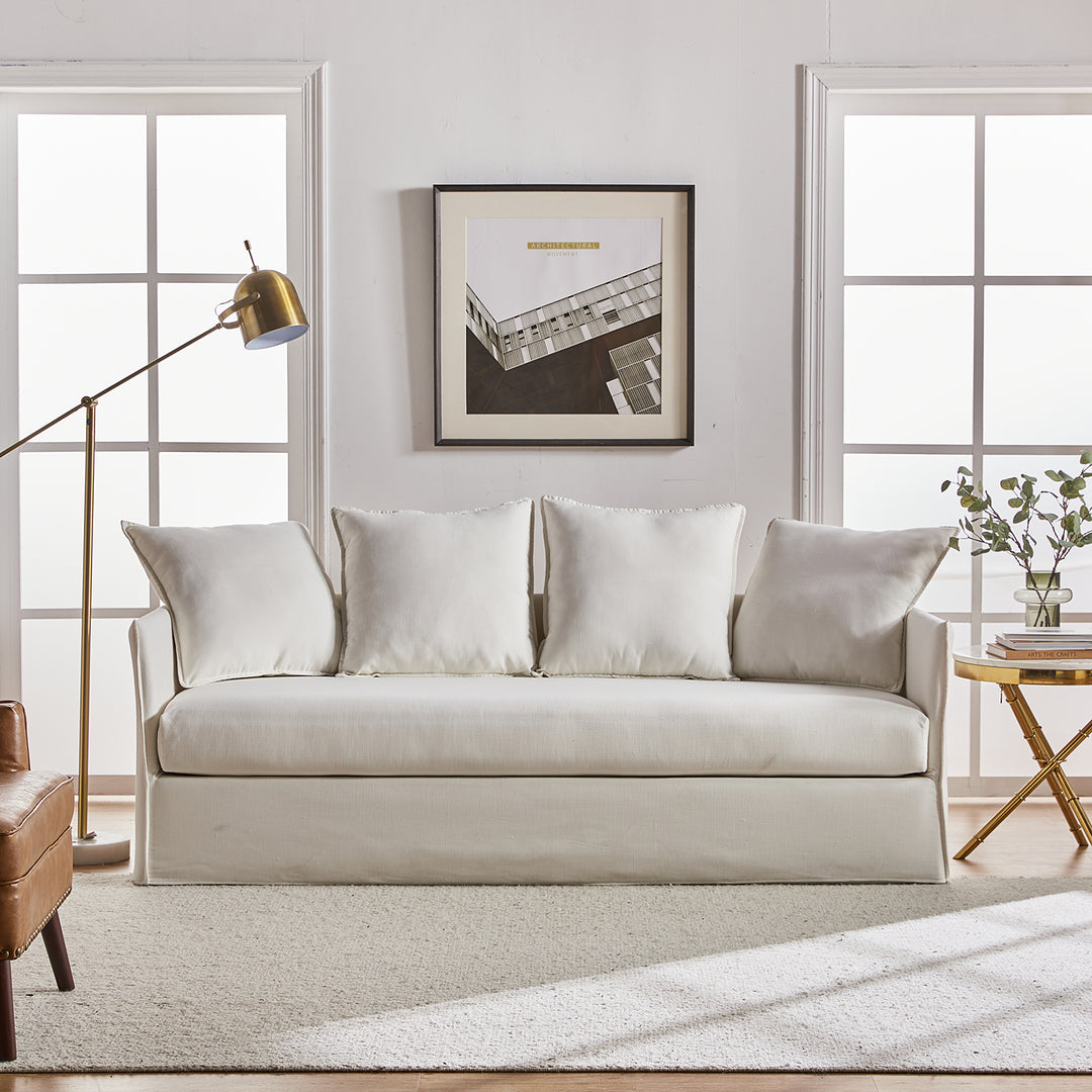 White slipcovered sofa with seating and clean modern silhouette in a modern living room space