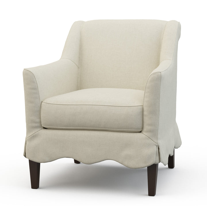 Beige armchair with scalloped skirt on a white background Coastal Compass