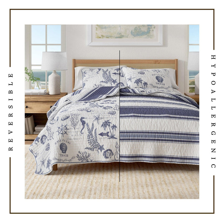 Reversible blue and white calypso quilt set on a bed with coastal patterns in a bedroom setting.