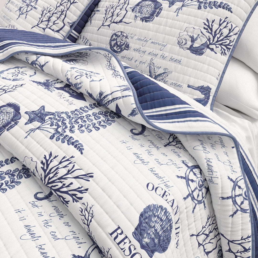 Calypso Nautical-themed quilt with blue and white designs on a white background