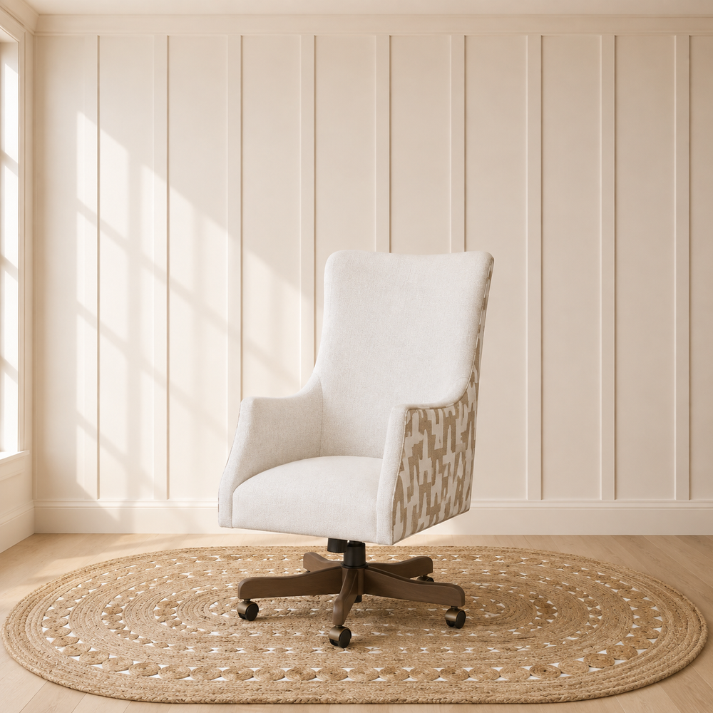 A modern swivel office chair with a light beige upholstered seat and back, patterned beige and white side panels, and a dark wood five-star base, set on a round woven jute rug in a room with cream paneled walls and a window.