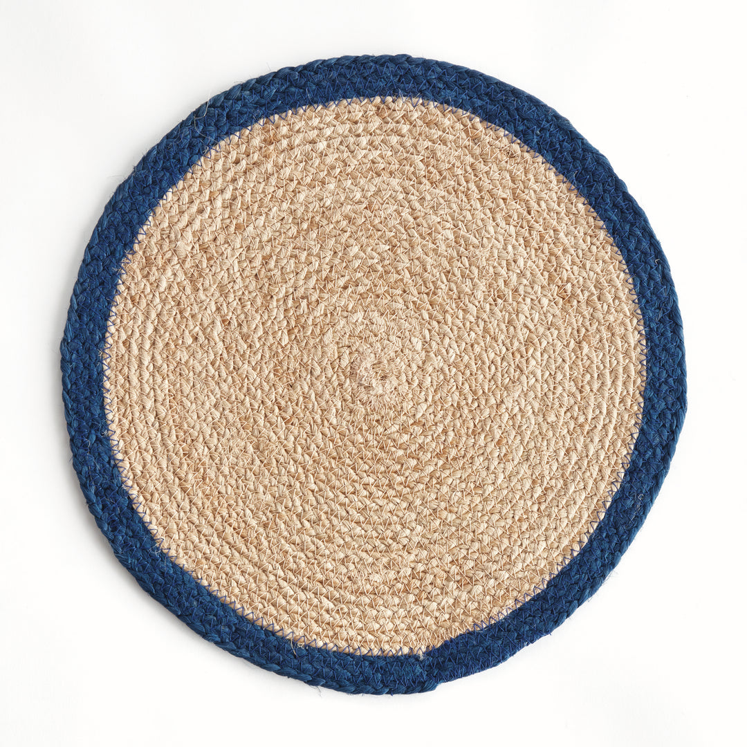 Round woven jute placemat with blue border on a white background