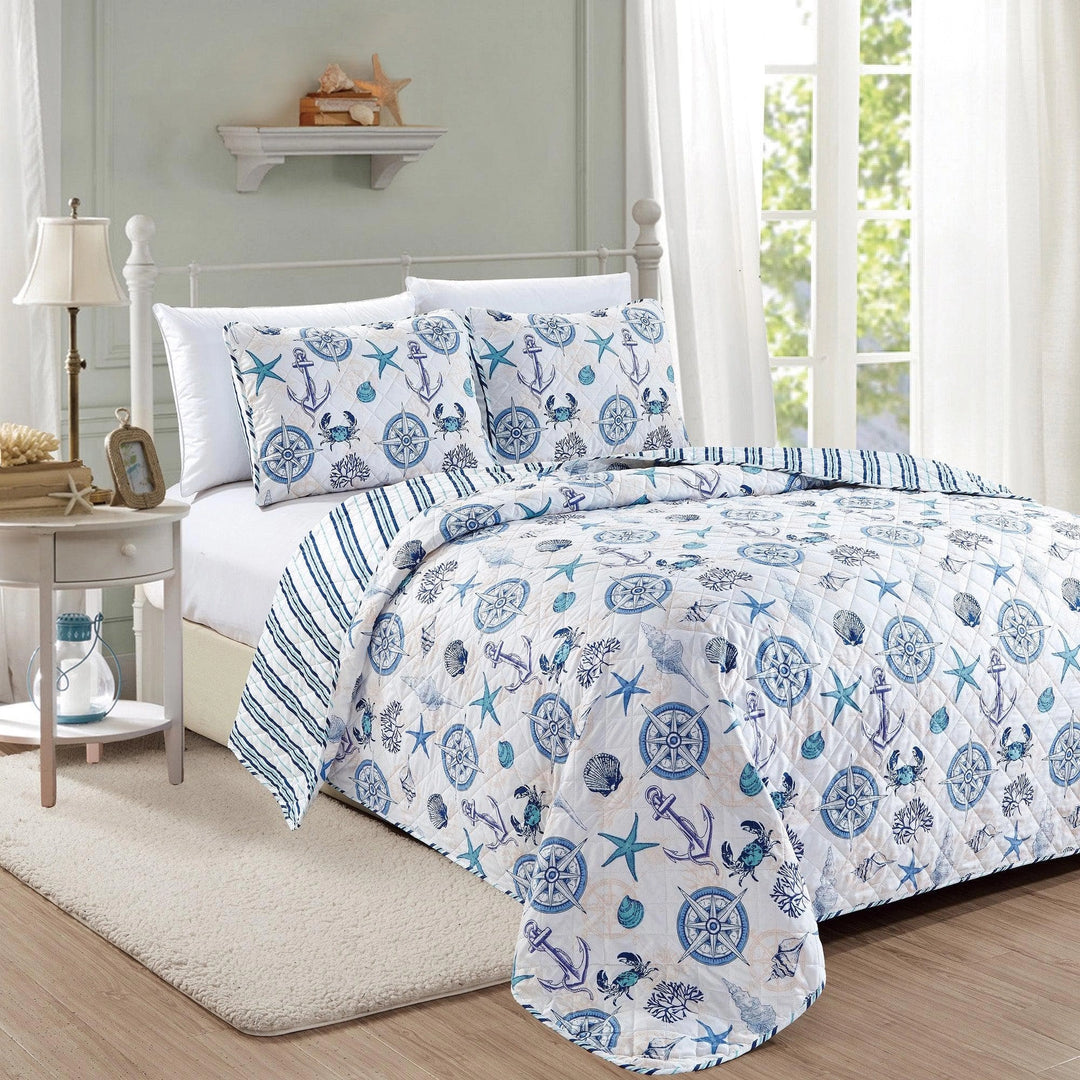 Bed with nautical-themed bedding in a bedroom setting