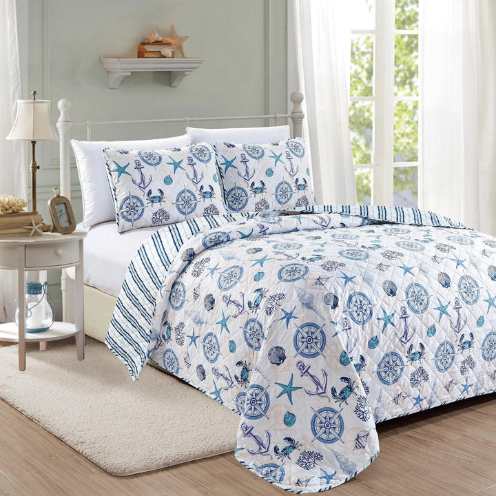 Bed with nautical-themed bedding in a bedroom setting