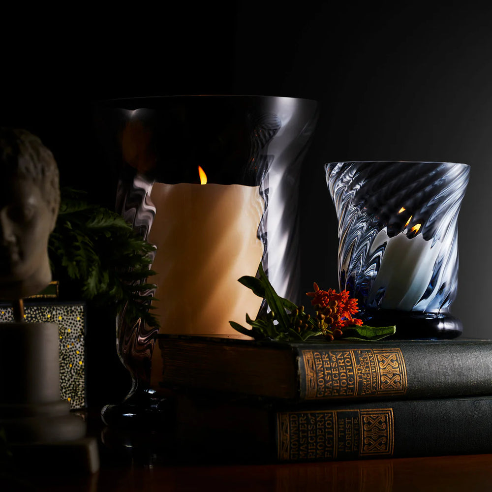 Costa votive glass candle holders on a book with decor