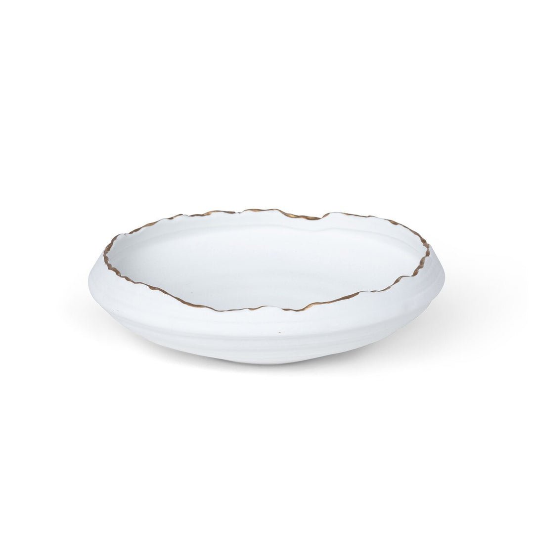 White ceramic bowl with gold rim on a white background
