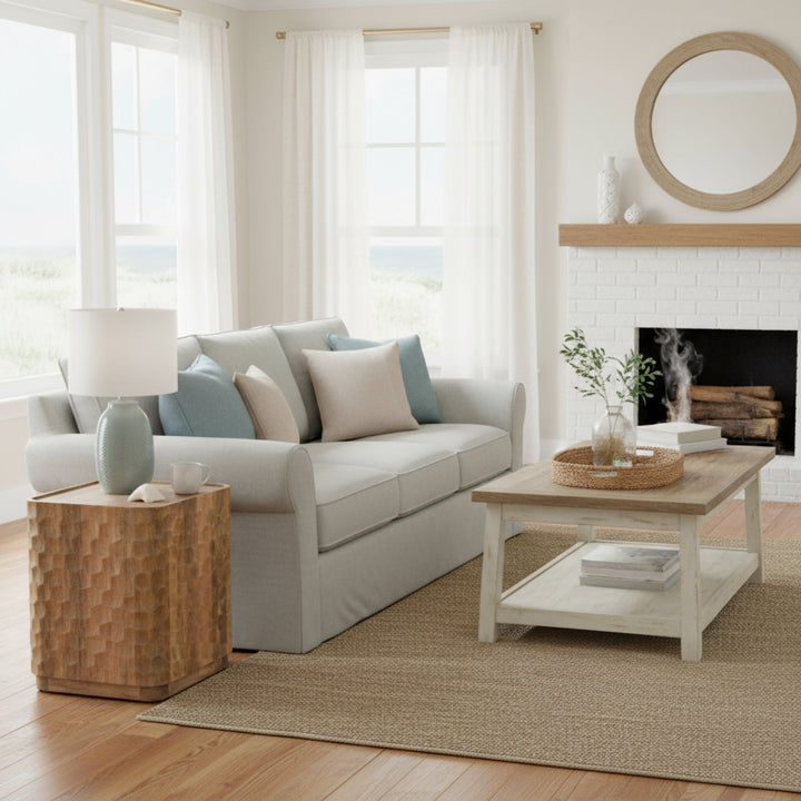 Modern living room with a gray sofa, wooden coffee table, and fireplace.