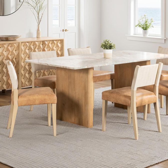 Duneview leather and linen dining chairs styled around wood dining table in a light coastal dining room