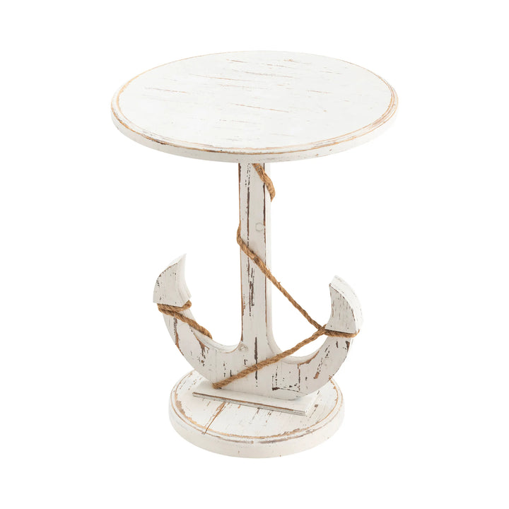 White distressed side table with an anchor design on a white background