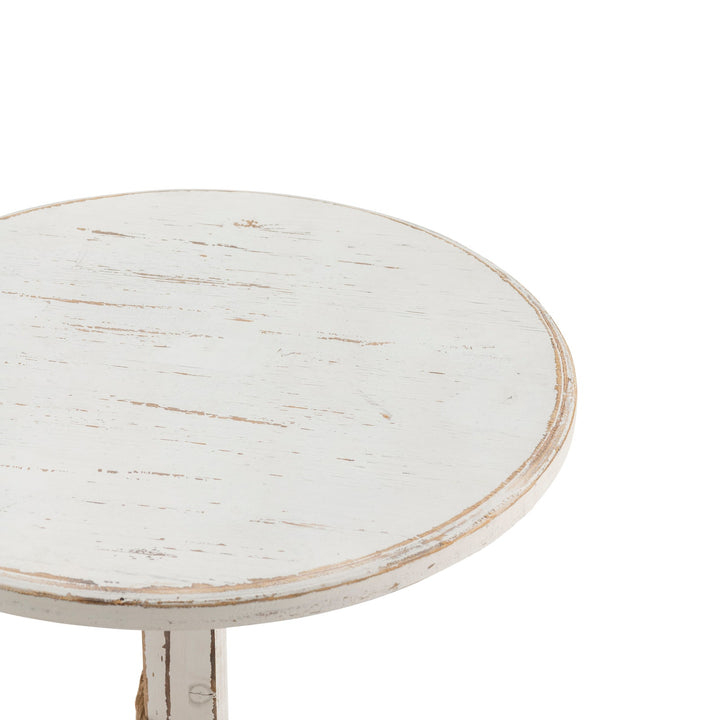 Round white distressed table on a white background