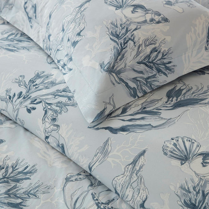 Close-up of blue coral reef and seashell pattern on Harbor Reef cotton sateen duvet cover