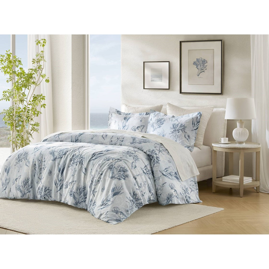 Blue coral reef coastal duvet cover set with matching shams in a light airy coastal bedroom