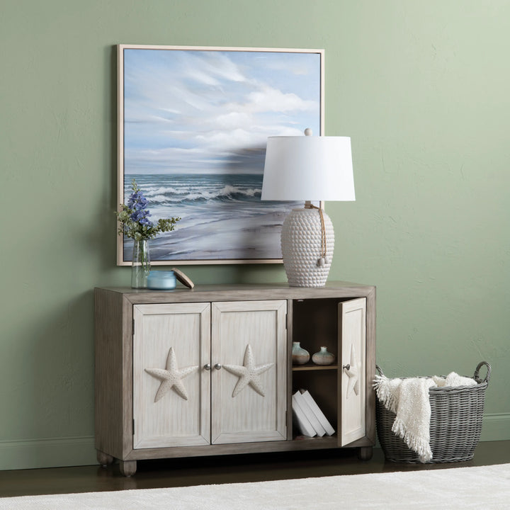 Room interior with a sideboard, lamp, and decorative items against a green wall.