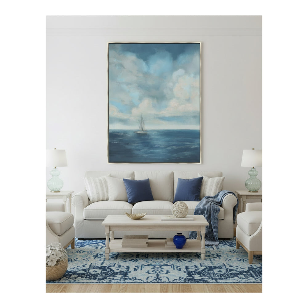 Living room with a large painting of a seascape above a sofa.