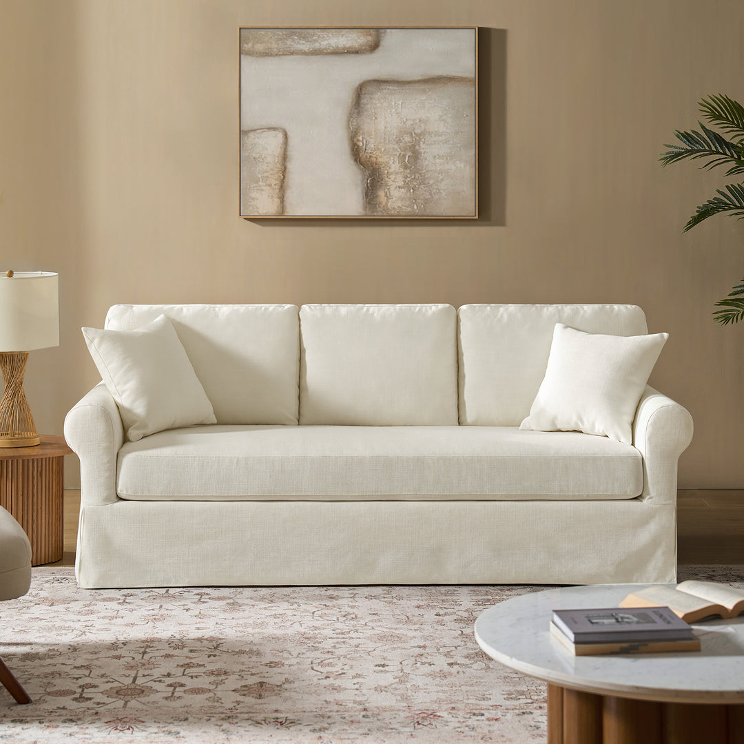 White linen slipcovered sofa in coastal living room with neutral decor and wood accents - Whitehaven sofa
