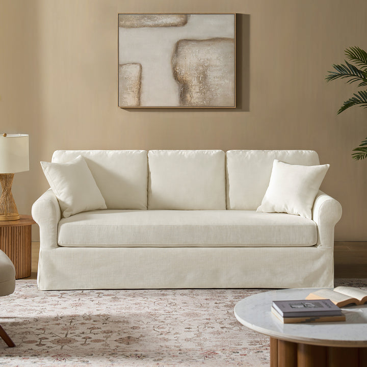 White linen slipcovered sofa in coastal living room with neutral decor and wood accents - Whitehaven sofa