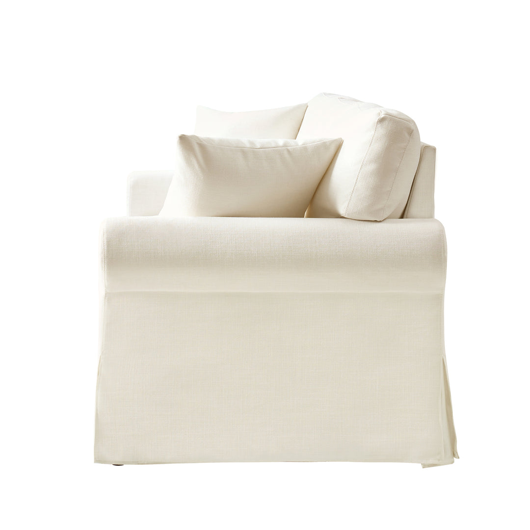 White linen slipcovered sofa side view with rolled arm and soft neutral upholstery - Whitehaven sofa