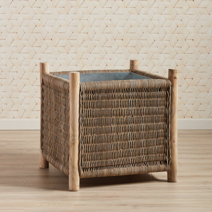 London Grand rattan planter styled against woven wall backdrop in coastal space