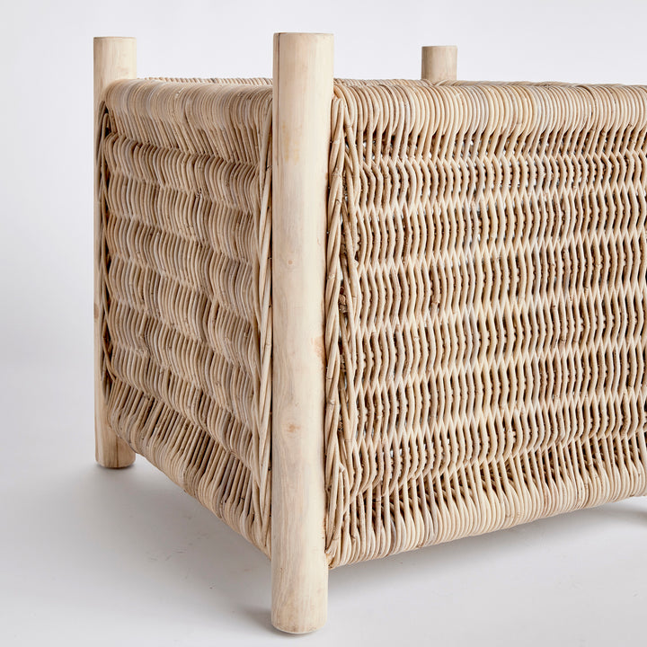 London Grand woven rattan planter with solid teak legs and square silhouette