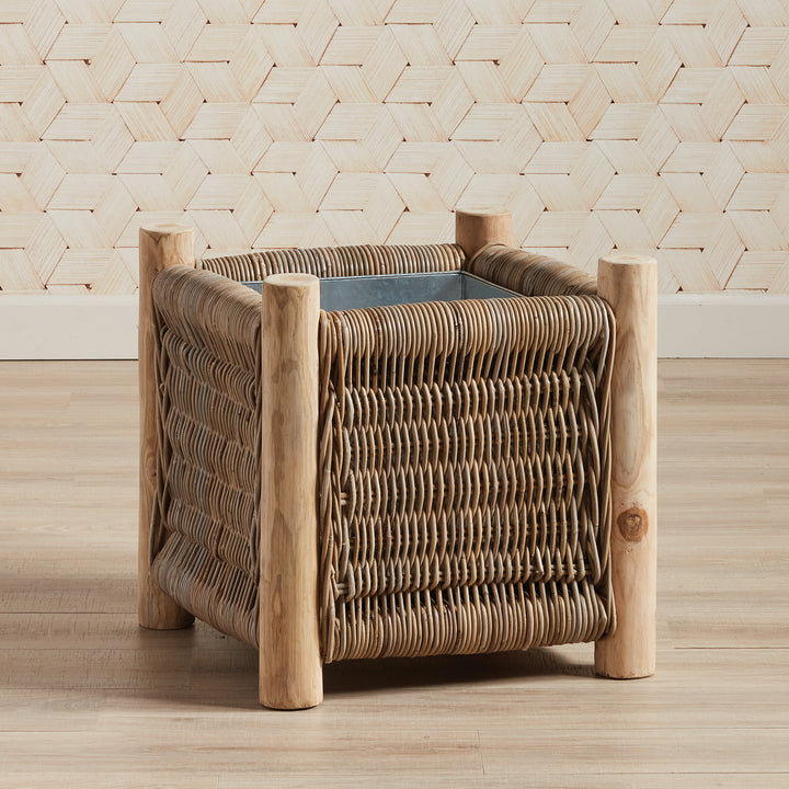 London Small woven rattan planter styled in coastal interior with natural wood flooring