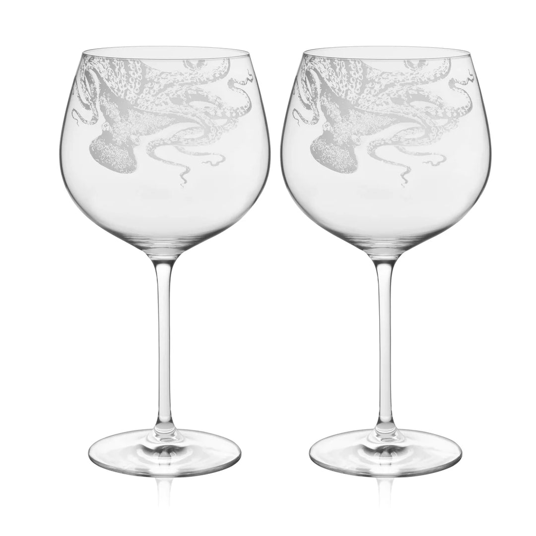 Two clear wine glasses with intricate designs on a white background