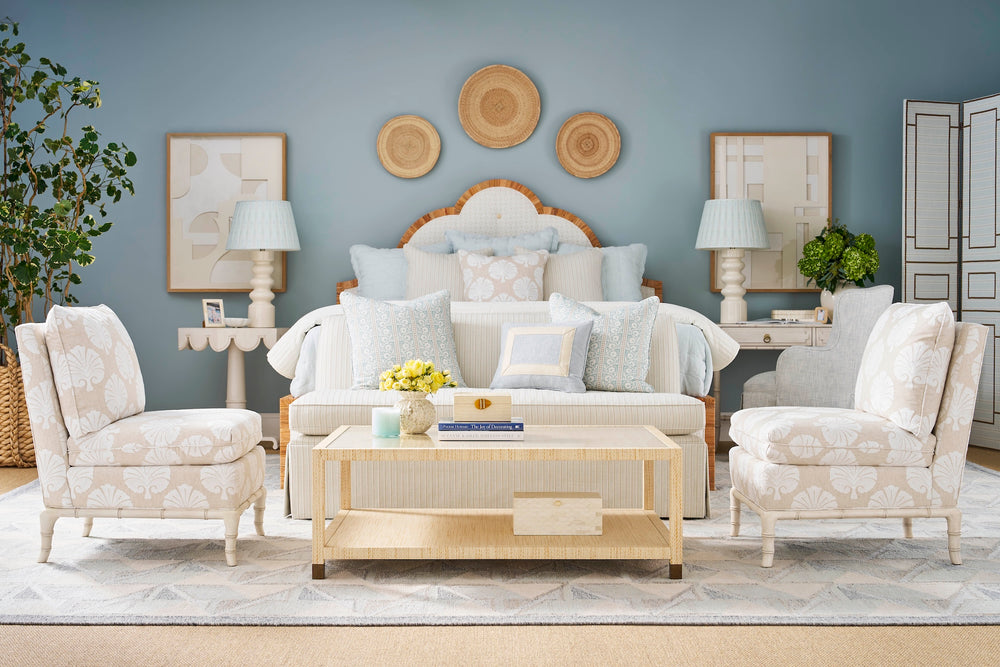 Bedroom with white furniture, decorative pillows, and a coffee table. Coastal Compass Home Decor