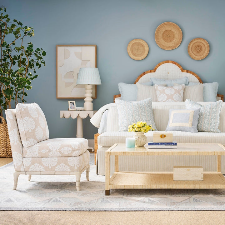 Bed room with white furniture, decorative pillows, and a coffee table.