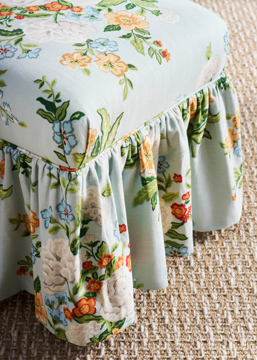 Floral-patterned chair cover on a chair with a textured floor background