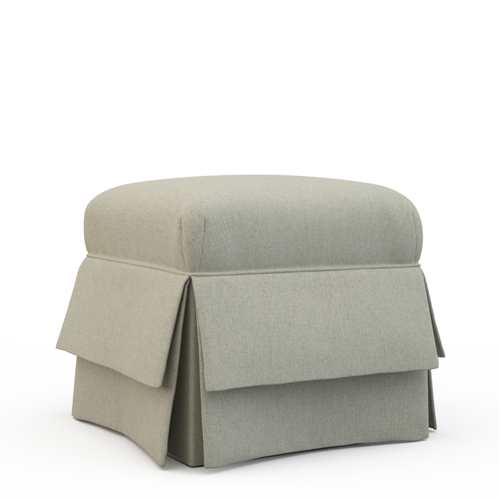 Gray ottoman with a pleated skirt on a white background