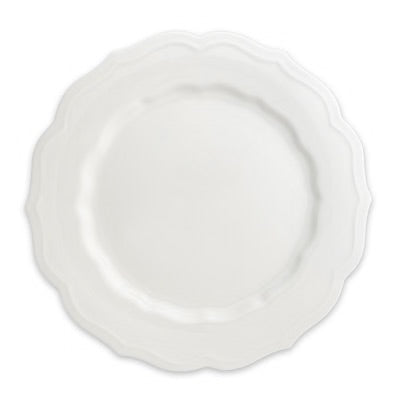 A white ceramic plate with a scalloped rim, shown from a top-down view on a white background.