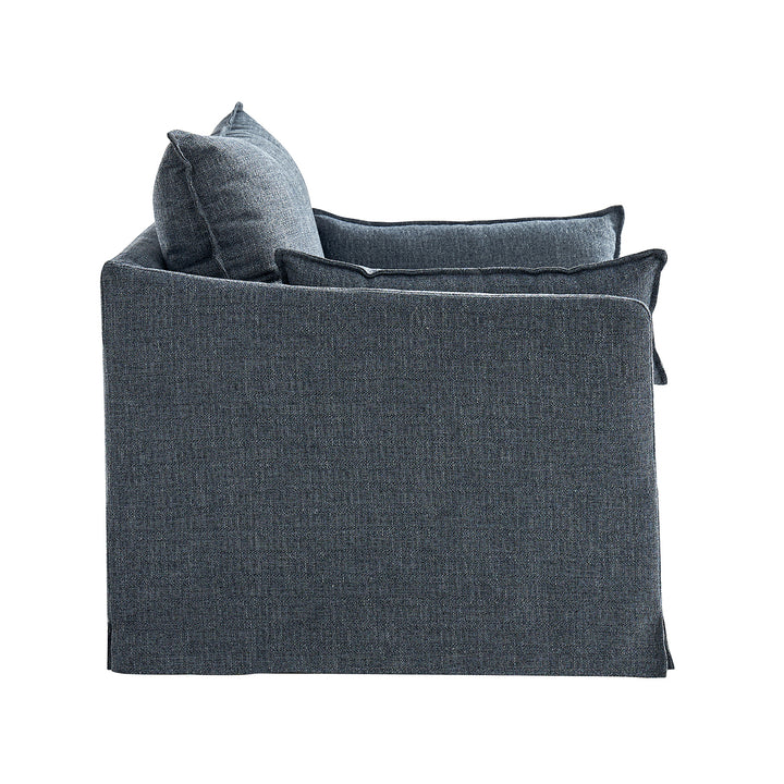 Side view of slipcovered armchair showing tailored edges and soft silhouette
