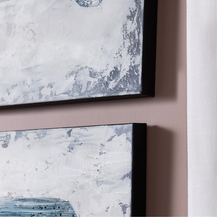 Two framed abstract artworks on a wall with a neutral background
