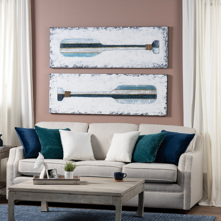 Living room with a beige sofa, wooden coffee table, and abstract wall art.