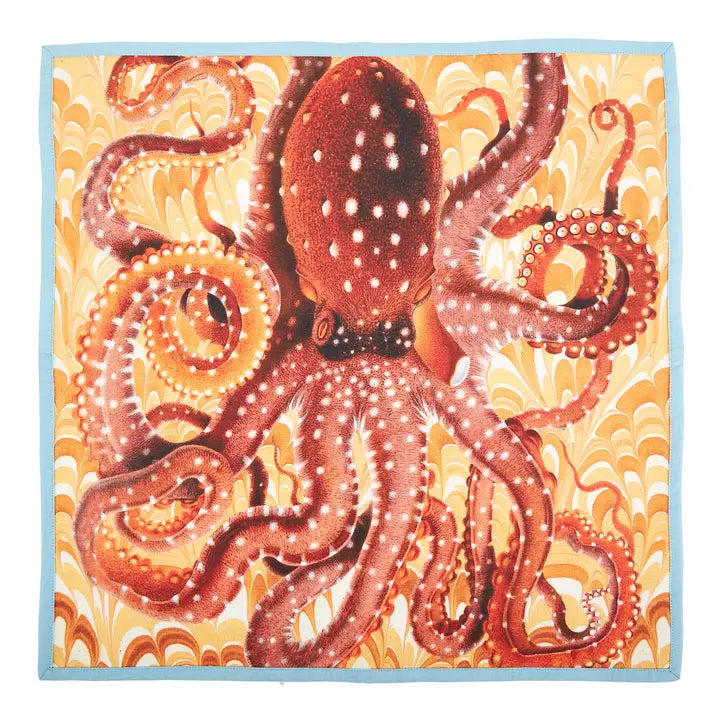 Colorful coastal cotton napkin featuring a vibrant octopus illustration on a marbled yellow and coral background with light blue trim.