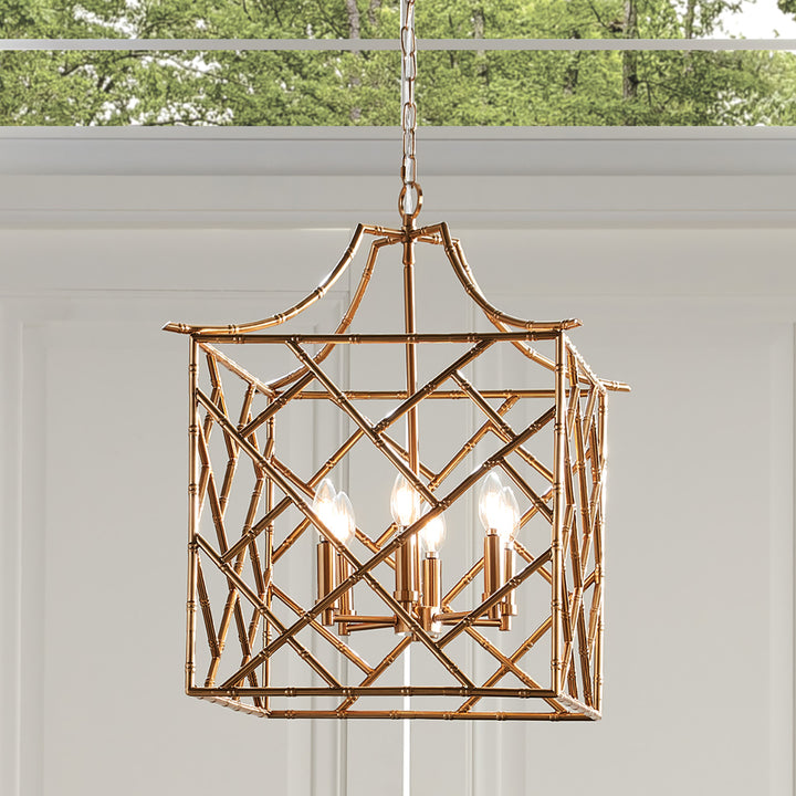 Decorative brass chandelier hanging against a neutral background. Coastal Compass Home Decor
