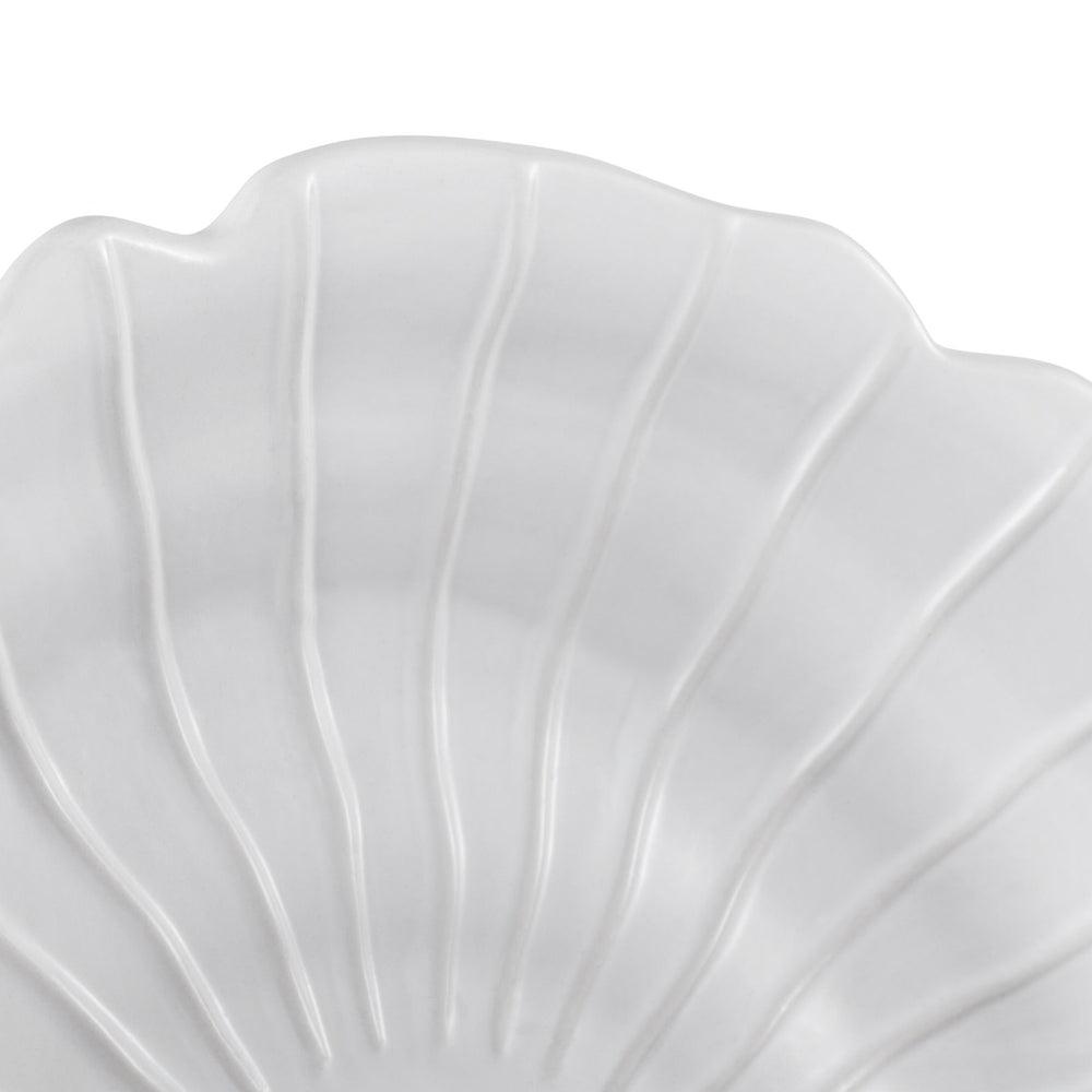 Close-up of ceramic sandstone spiral wall art showing ridged shell texture