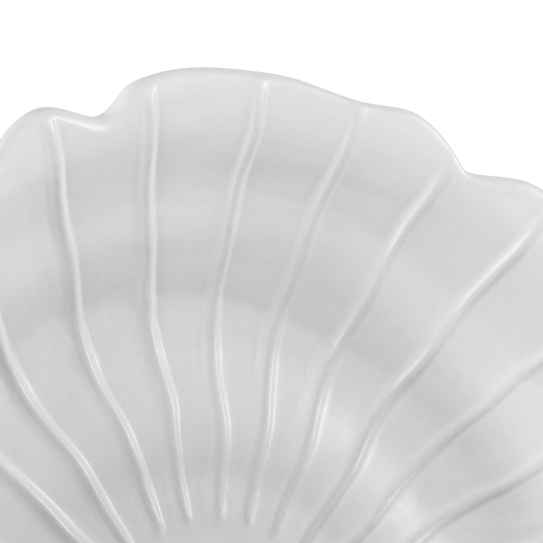 Close-up of ceramic sandstone spiral wall art showing ridged shell texture