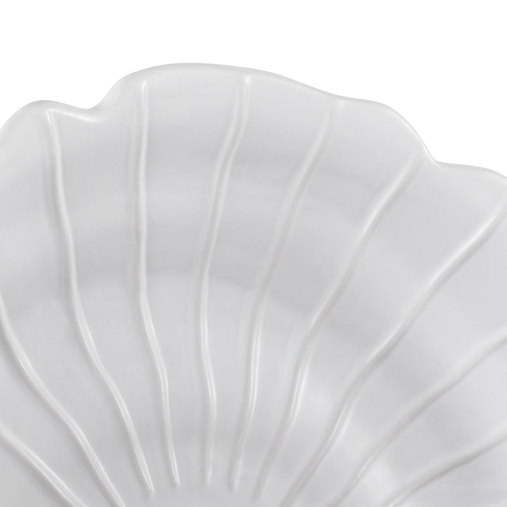 Close-up of ceramic sandstone spiral wall art showing ridged shell texture