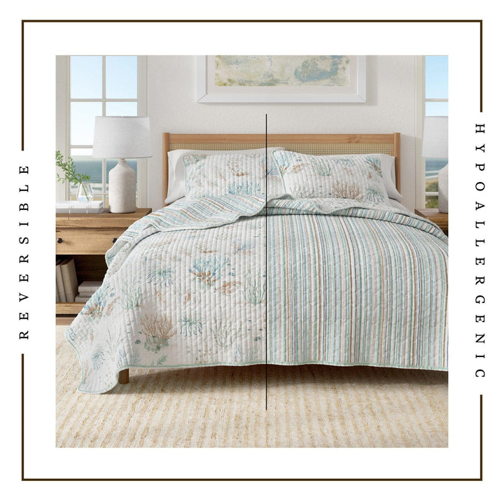 Santa Barbara Quilt Set with a reversible striped pattern in an airy coastal bedroom setting, featuring text 'Hypoallergenic' and 'Reversible'.