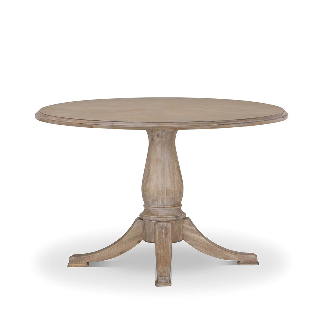 Santorini Pedestal Dining Table full view in whitewash finish with round top and carved base