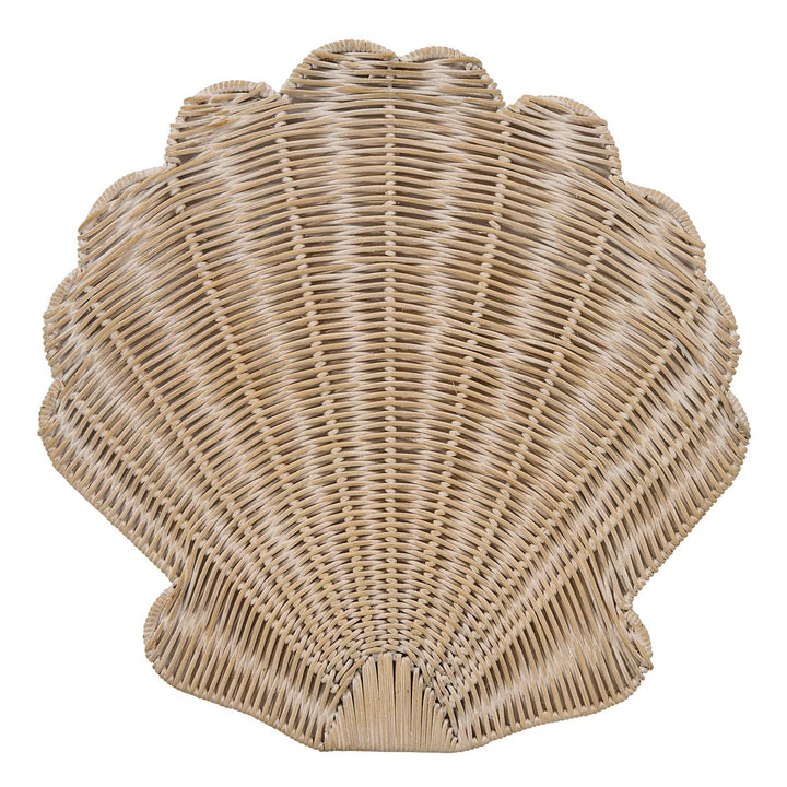 A scallop-shaped woven rattan placemat in a natural light tan color, isolated on a white background.